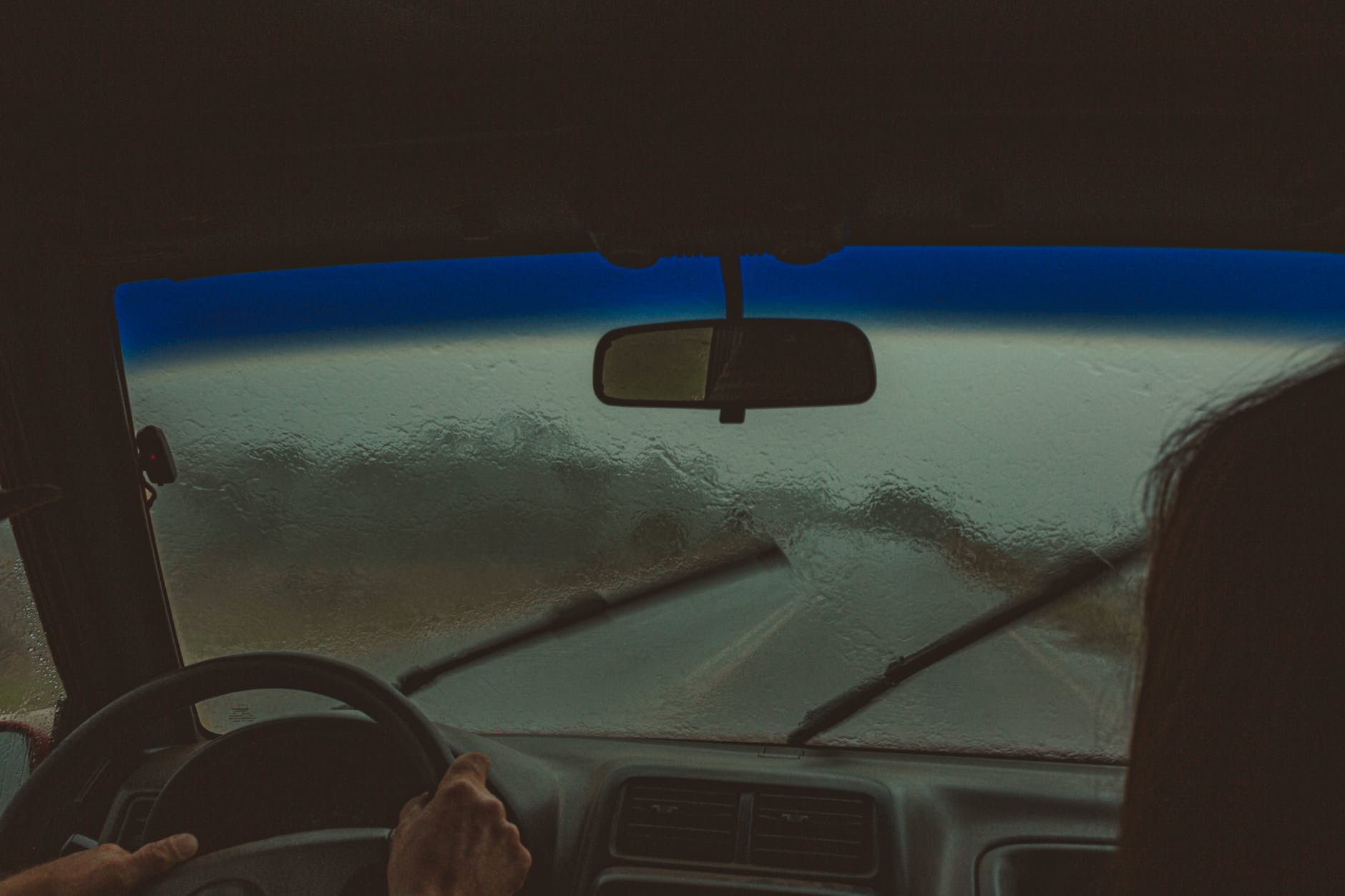 crop travelers in car in rainy day
